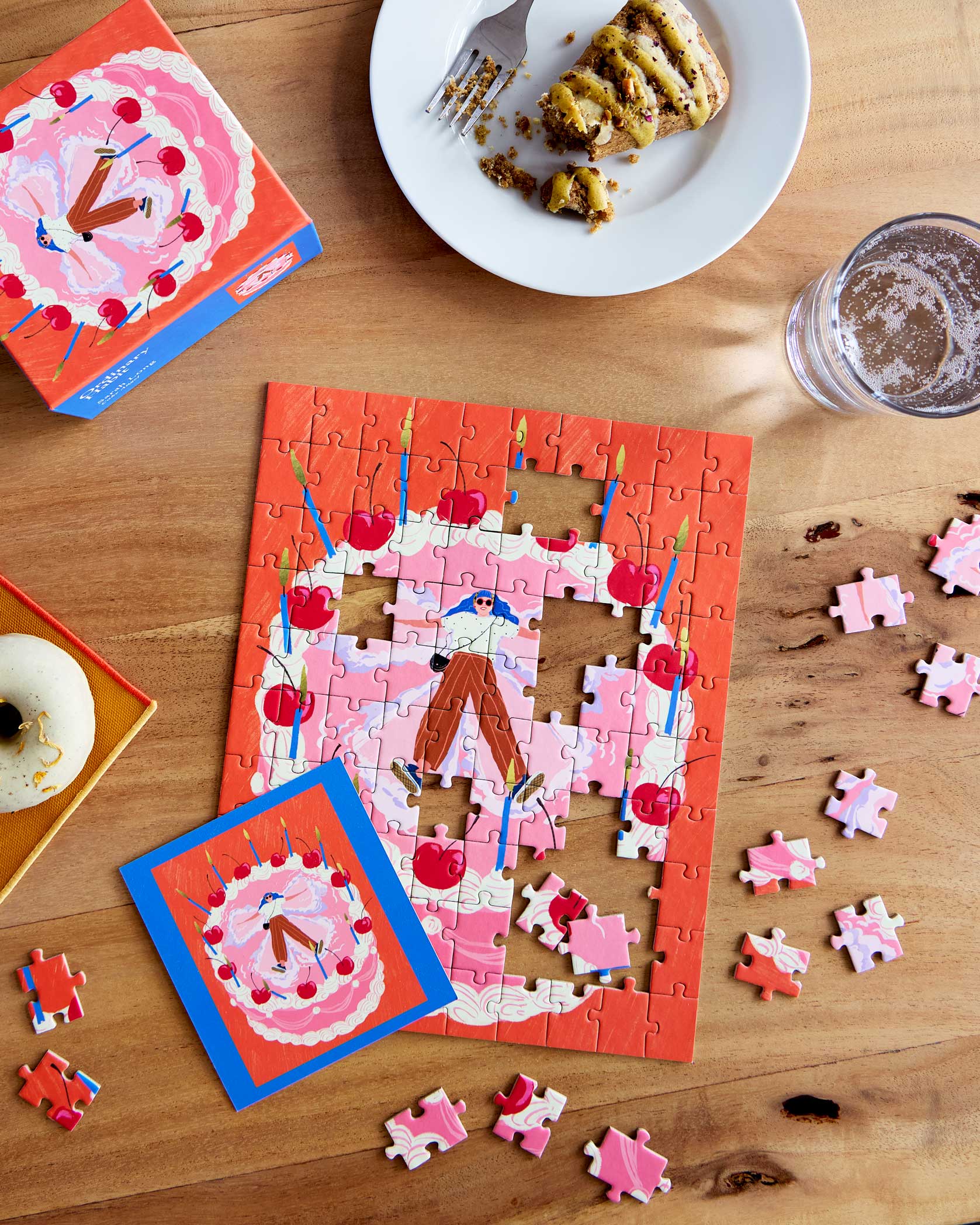 Cake Angel 100 Piece Mini Puzzle by Ordinary Habit - on a table with snacks
