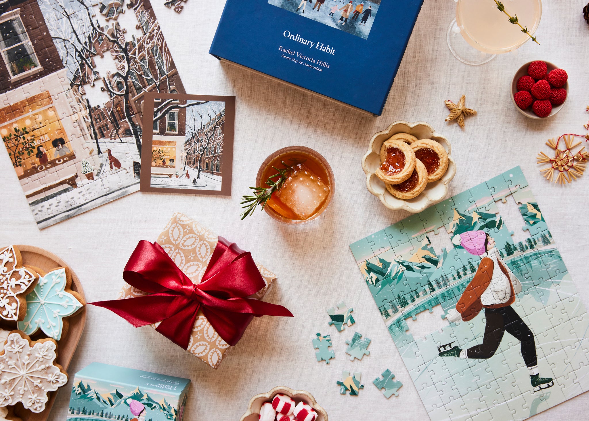 Tabletop scene with a gift, Ordinary habit puzzle, and decorative items on a light surface.
