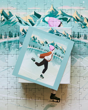 "The Skater" Jigsaw puzzle with a completed section showing a person ice skating in a mountainous landscape.