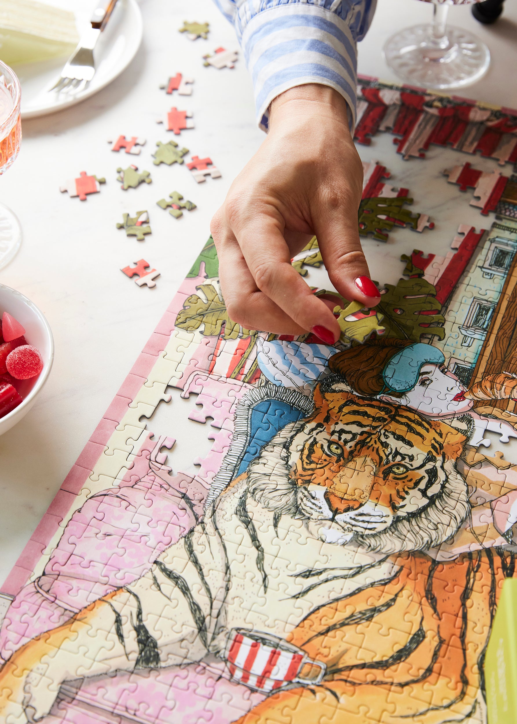 Wild Comfort 1000 Piece Puzzle by Ordinary Habit with person putting a piece in place